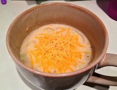 a bowl of soup with cheese on top