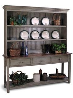 a wooden shelf with plates and bowls on it