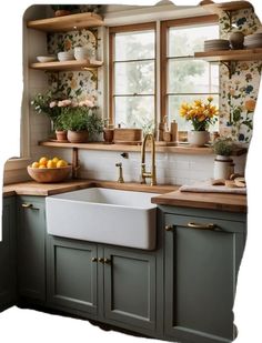 a kitchen with green cabinets and yellow flowers on the window sill above the sink