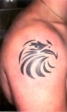 an eagle tattoo on the back of a man's shoulder