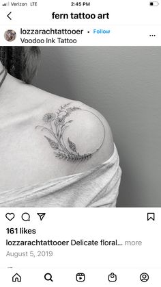 the back of a woman's shoulder with tattoos on it