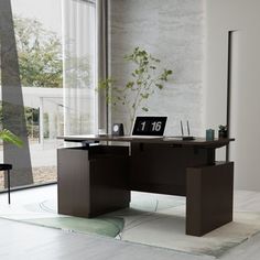 an office desk in front of a large window