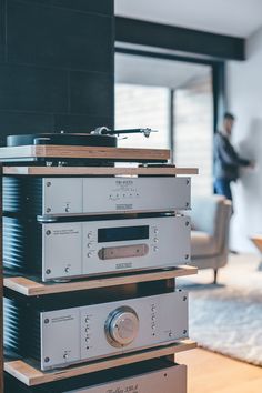 a stack of stereo equipment sitting on top of a wooden table