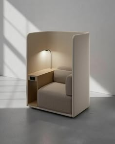 a chair that is sitting in the middle of a room with a lamp on it