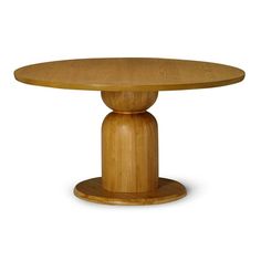 a round wooden table sitting on top of a white floor