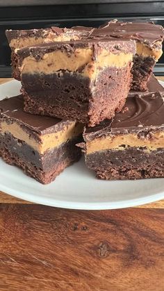 three pieces of chocolate peanut butter brownies stacked on top of each other