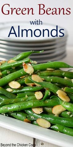 green beans with almonds on a white plate