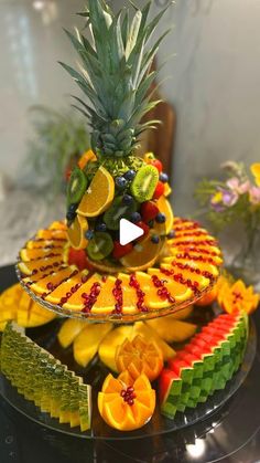 a fruit platter with pineapples, oranges, and other fruits