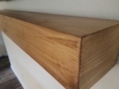 a close up of a wooden shelf on the wall