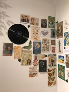 a wall covered with lots of different types of cards and pictures on it's side