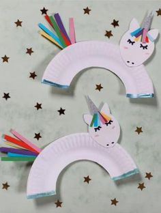 two paper plates with unicorns on them, one has rainbow hair and the other has stars