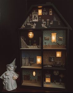 a doll house with lights and decorations on it