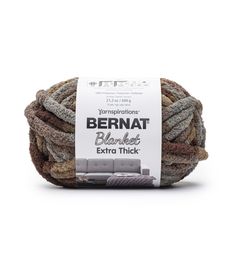 bernat blanket extra thick yarn in grey and brown colors on a white background with a tag