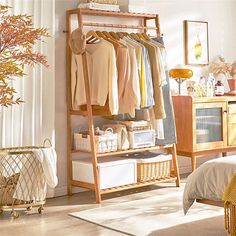 a clothes rack in a bedroom next to a bed