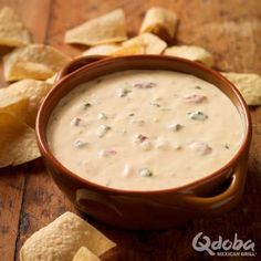 a bowl of dip surrounded by tortilla chips