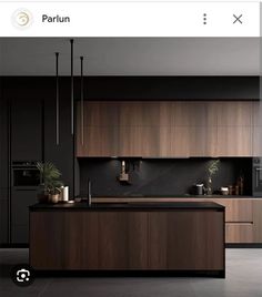 an image of a modern kitchen setting with wood cabinets and black countertops, along with potted plants