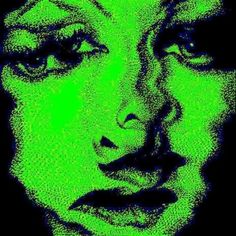 a woman's face is lit up in green and black, while the image shows her eyes