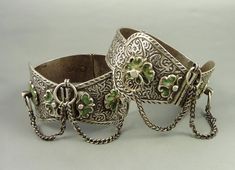 "Pair of Amazigh/Berber cast silver anklets inspired from the oldest Meknes and Fez types, probably made in Marrakesh or Essaouira. Made of high-grade silver. The green enamel could be a later addition. The ram's head hallmark indicates it is post-1925, from around mid 20th century. Dimensions: Diameter: 8 cm (3,15 inches) Width (widest point): 5 cm (1,97 inches) Weight: 360 gr. References: \"Bijoux du Maroc\", Rabaté, Marie-Rose-Golderberg, André, Editions Eddif, 1999 \"Bijoux Berbéres Au Marro