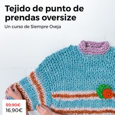 a woman is holding up a sweater with buttons on it