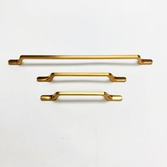 two brass handles on a white background