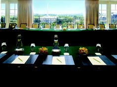 a long table is set up with place settings for two people to sit and eat