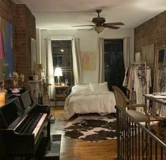 a bedroom with a bed, piano and window