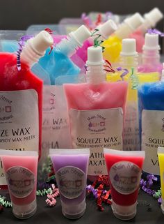 several different types of hand sanitizers are lined up on a table with confetti