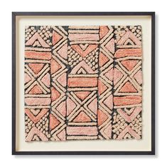 an orange and black framed art print with geometric designs on the front, in white frame