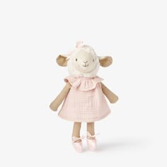 a stuffed sheep wearing a pink dress and ballet slippers on a white background with copy space for text