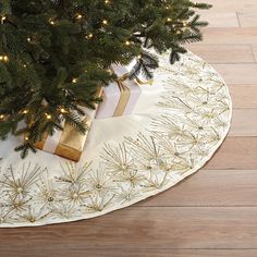 a christmas tree skirt with presents under it