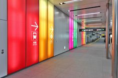 an empty subway station with brightly colored doors