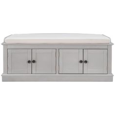 a white bench with two doors and drawers