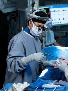 a man is performing surgery in an operating room