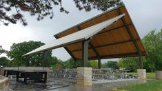 a covered picnic area with tables and chairs