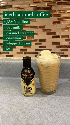 an iced caramel coffee drink next to a jar of whipped cream on a counter