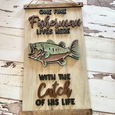 a wooden sign that says, one fine fisherman lives here with the catch of his life