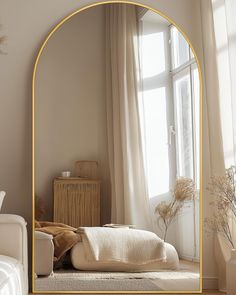 an arch shaped mirror in the middle of a room