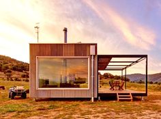 a small house sitting on top of a grass covered field