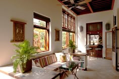 a living room filled with furniture and lots of windows