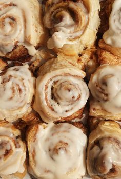 cinnamon rolls with icing sitting on top of each other