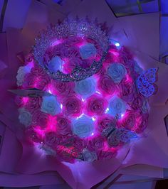 a bouquet of pink roses with lights in the middle