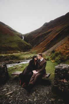 A couple sitting by a waterfall in Scotland Scotland Travel, Most Romantic