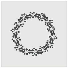 a christmas wreath with holly branches and berries in the center, cut out from paper