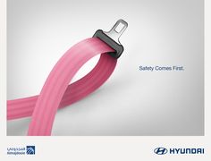 a pink ribbon with the words safety comes first on it and an image of a black buckle