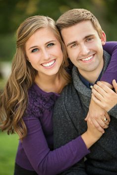 a young man and woman hugging each other