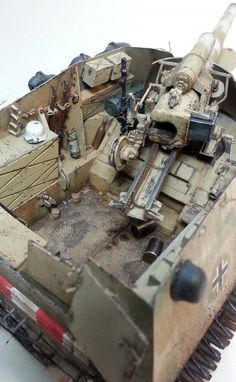 a close up of a toy tank on a white surface