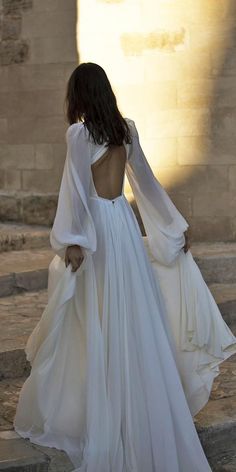 the back of a woman's white wedding dress