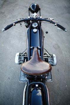 the front end of a blue motorcycle parked in a parking lot