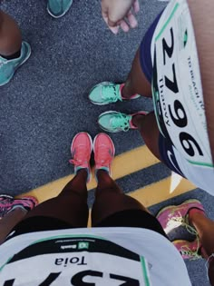 two people standing next to each other with their feet on the ground and wearing running shoes