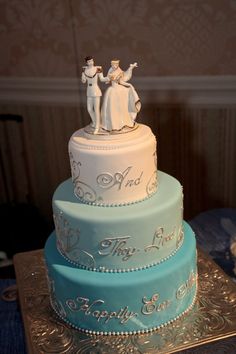 three tiered wedding cake with figurines on top